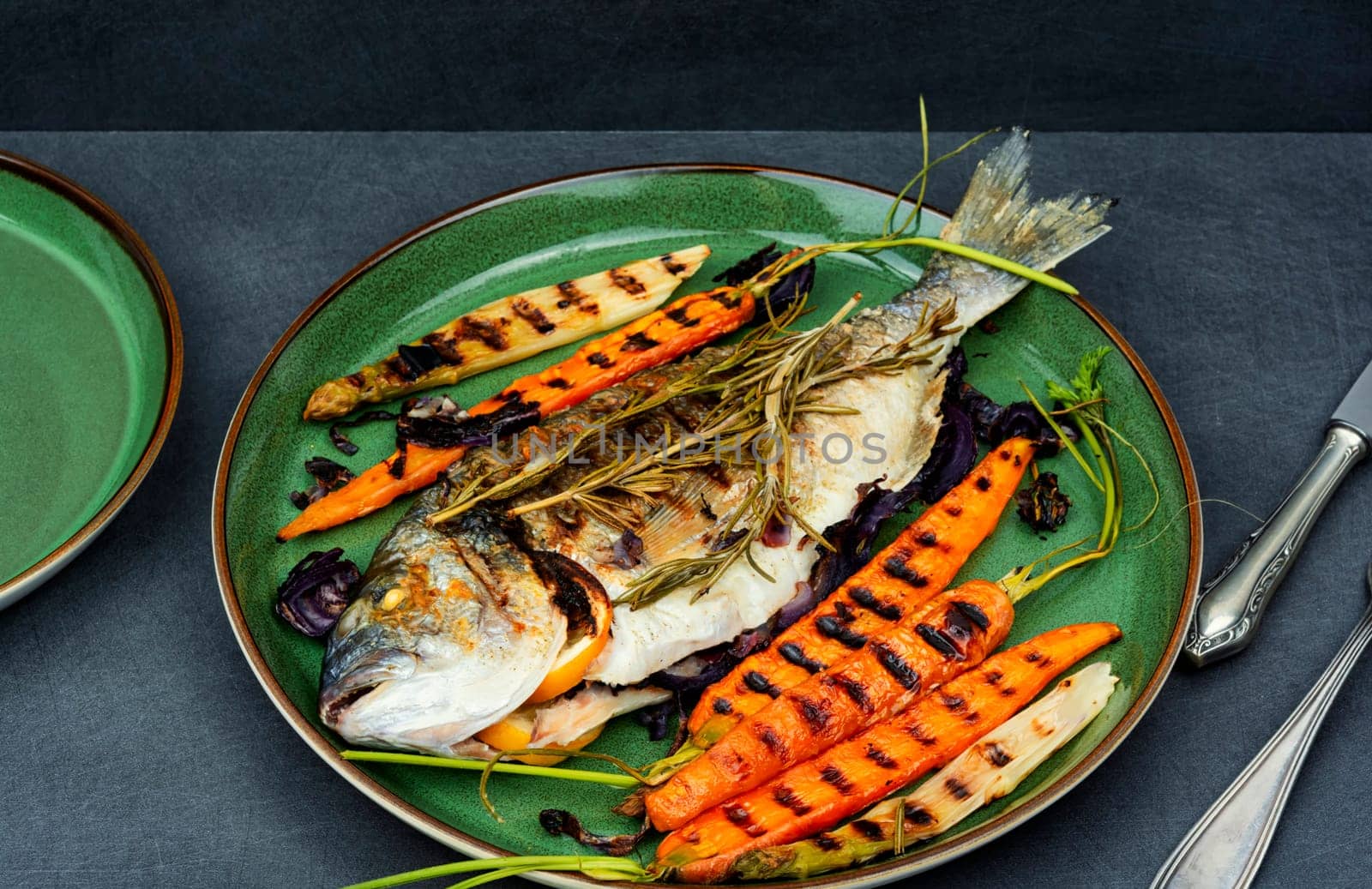 Barbecue whole dorado fish or sea bream with grilled vegetables. BBQ fish