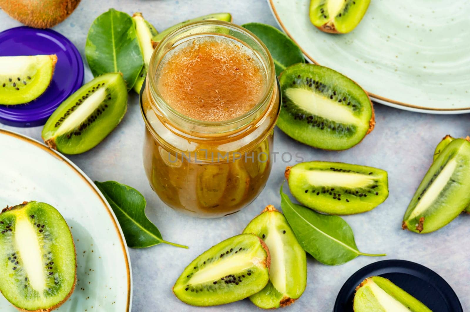 Delicious kiwi jam in a glass jar. Top view. Space for text