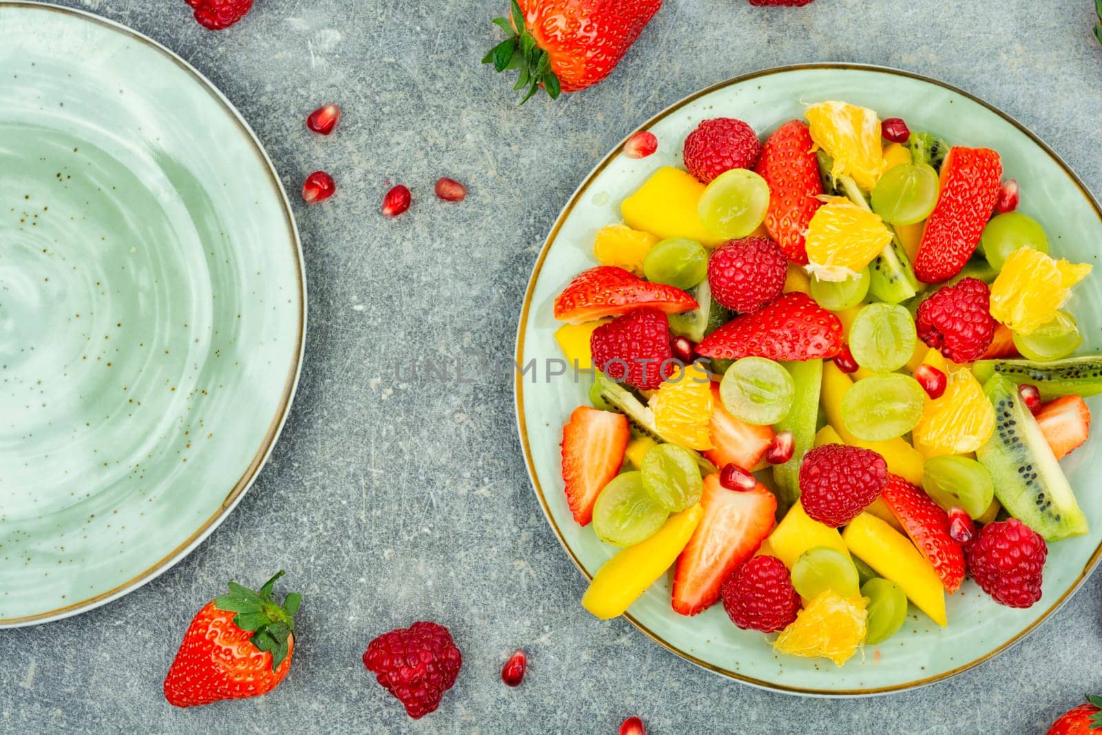 Fresh salad of mango, citrus, banana and ripe berries. Top view