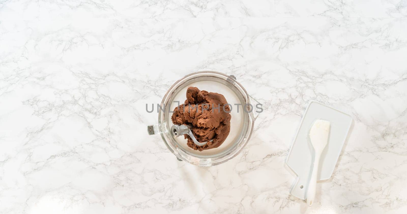 Top-down view of a glass bowl filled with combined cookie dough for Pale Gingerbread Cookies with Subtle Spice Flavor. The dough appears evenly mixed and pale in color, ready for wrapping and chilling.