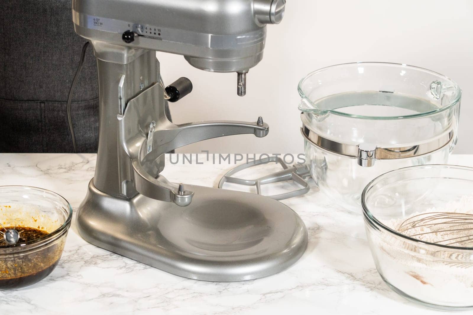 A stand mixer with softened butter and brown sugar in the bowl, ready to be creamed together for the Zesty Orange Gingerbread Cookie Dough recipe. Mixing these ingredients adds a soft texture and sweetness to the dough.