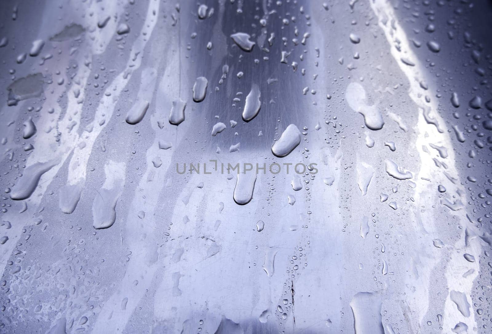 Detail of stainless steel surface wet from the rain
