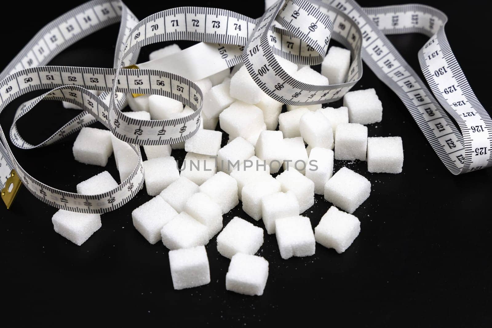 Cubes of white refined sugar on a black background. High quality photo