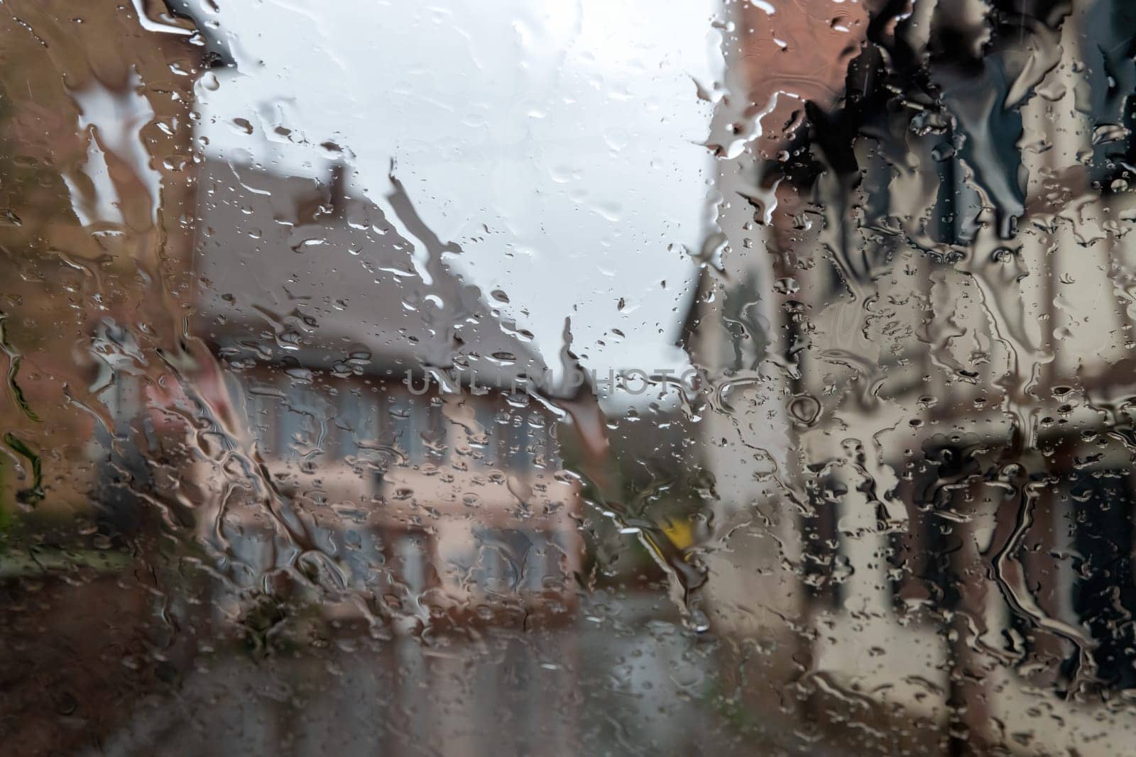 Raindrops on the glass, blurred background. Rainy weather.