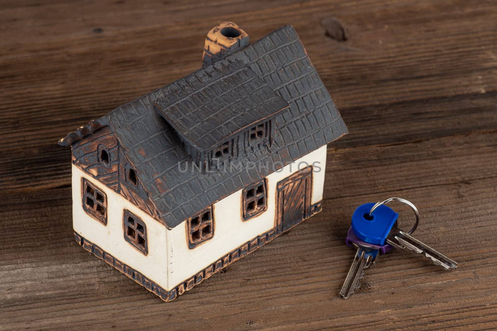 Model house and keys on table. Concept of dream house