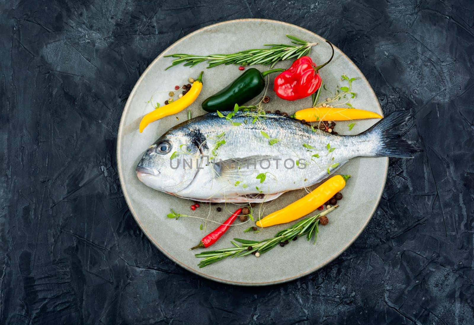 Raw dorado fish and spices with ingredients for cooking for cooking