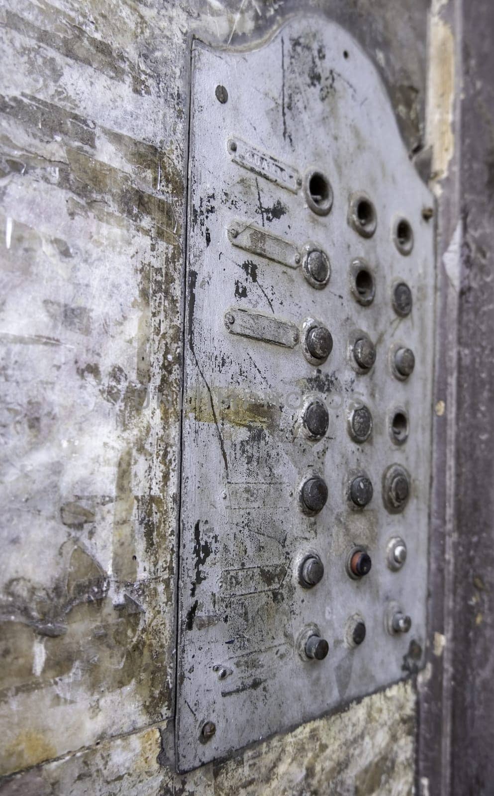 Detail of old entryphone in an abandoned house, ruin and dirt