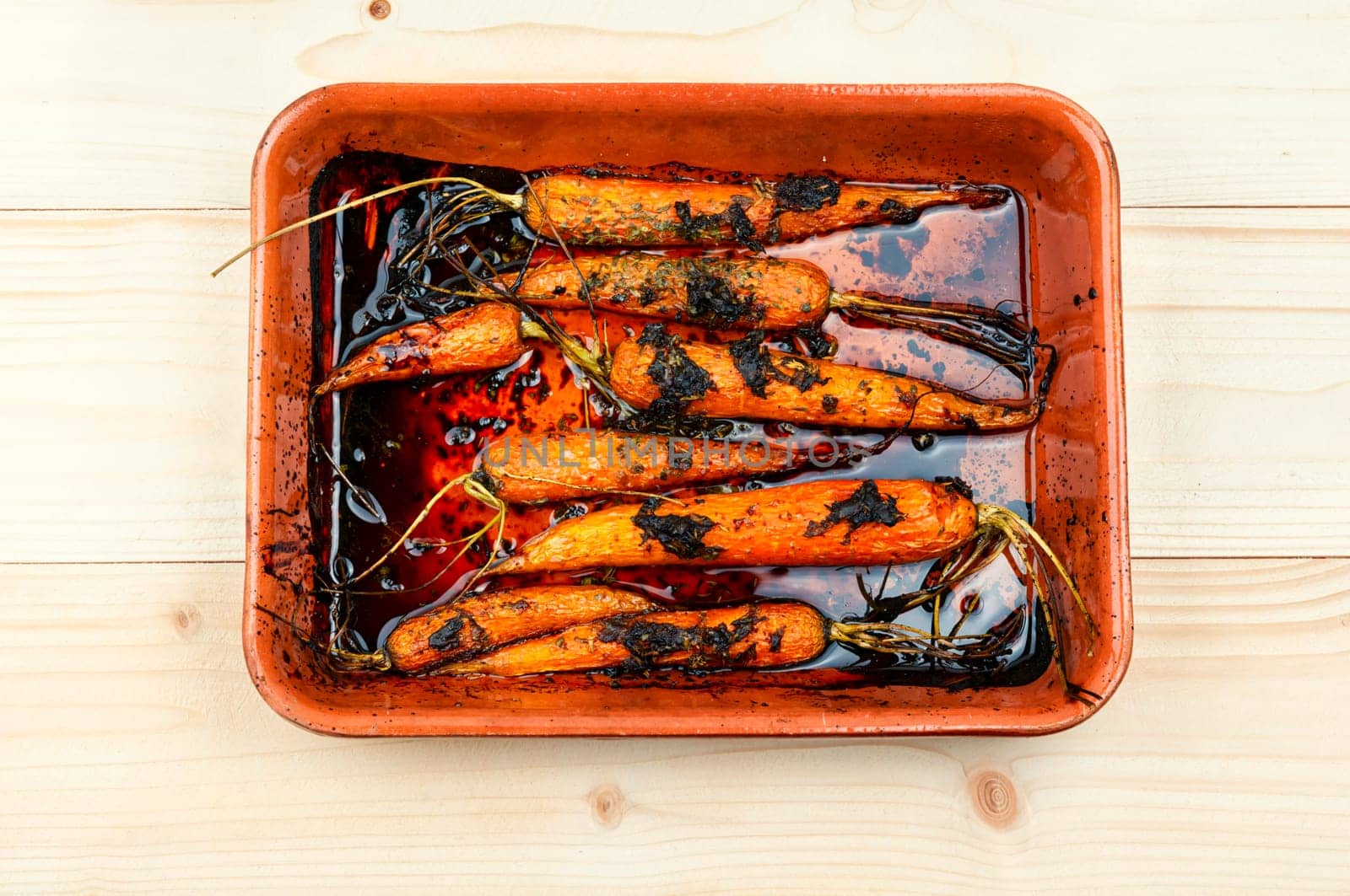 Baked carrots in a ceramic form. Top view