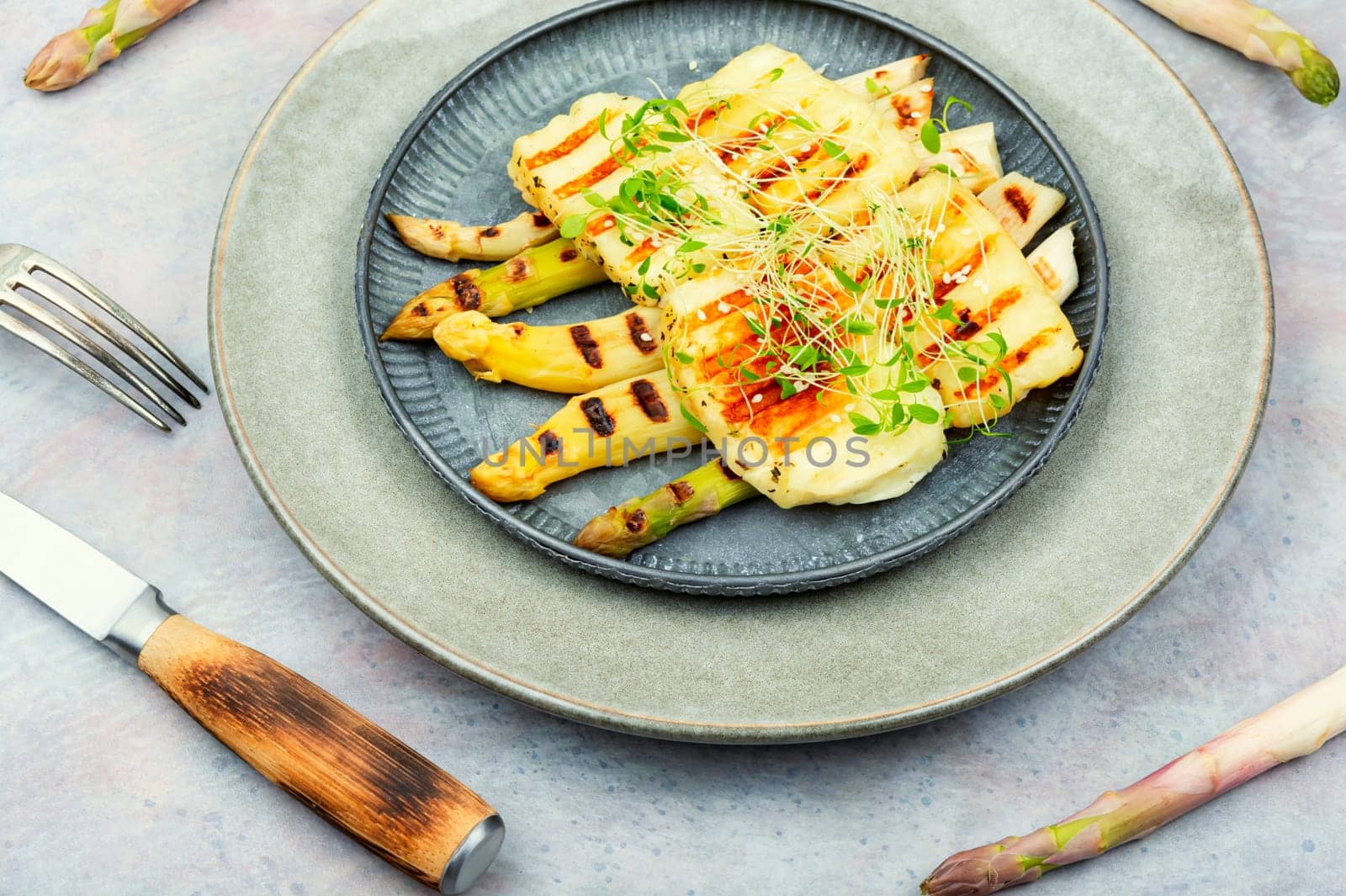 Warm salad with white asparagus and fried halloumi cheese. Healthy food, space for text