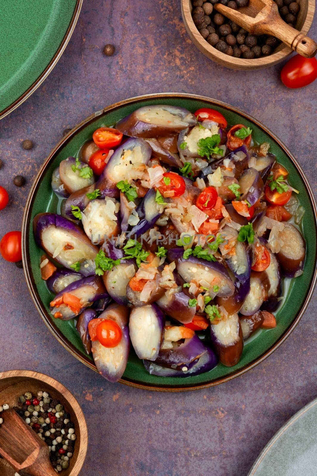 Spicy purple eggplant, tomato and garlic salad. Roast aubergine