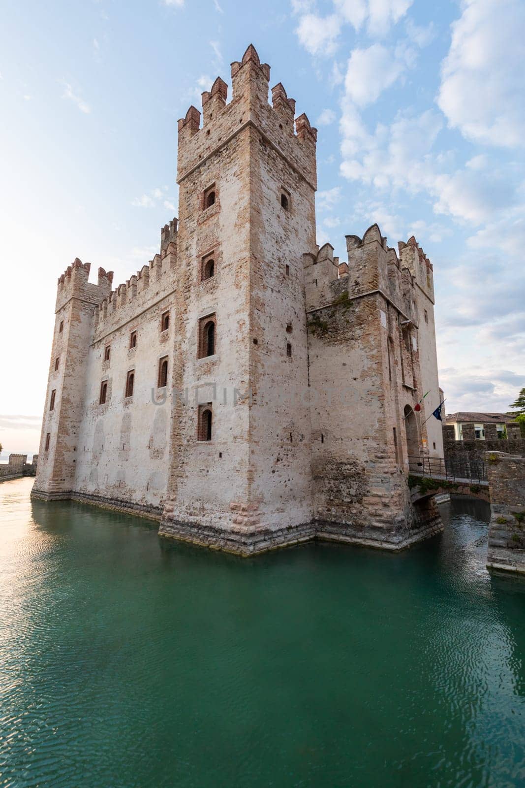 Sirmione, Italy - June 2022: Sirmione castle on Garda lake. Scenic mediaeval building on the water