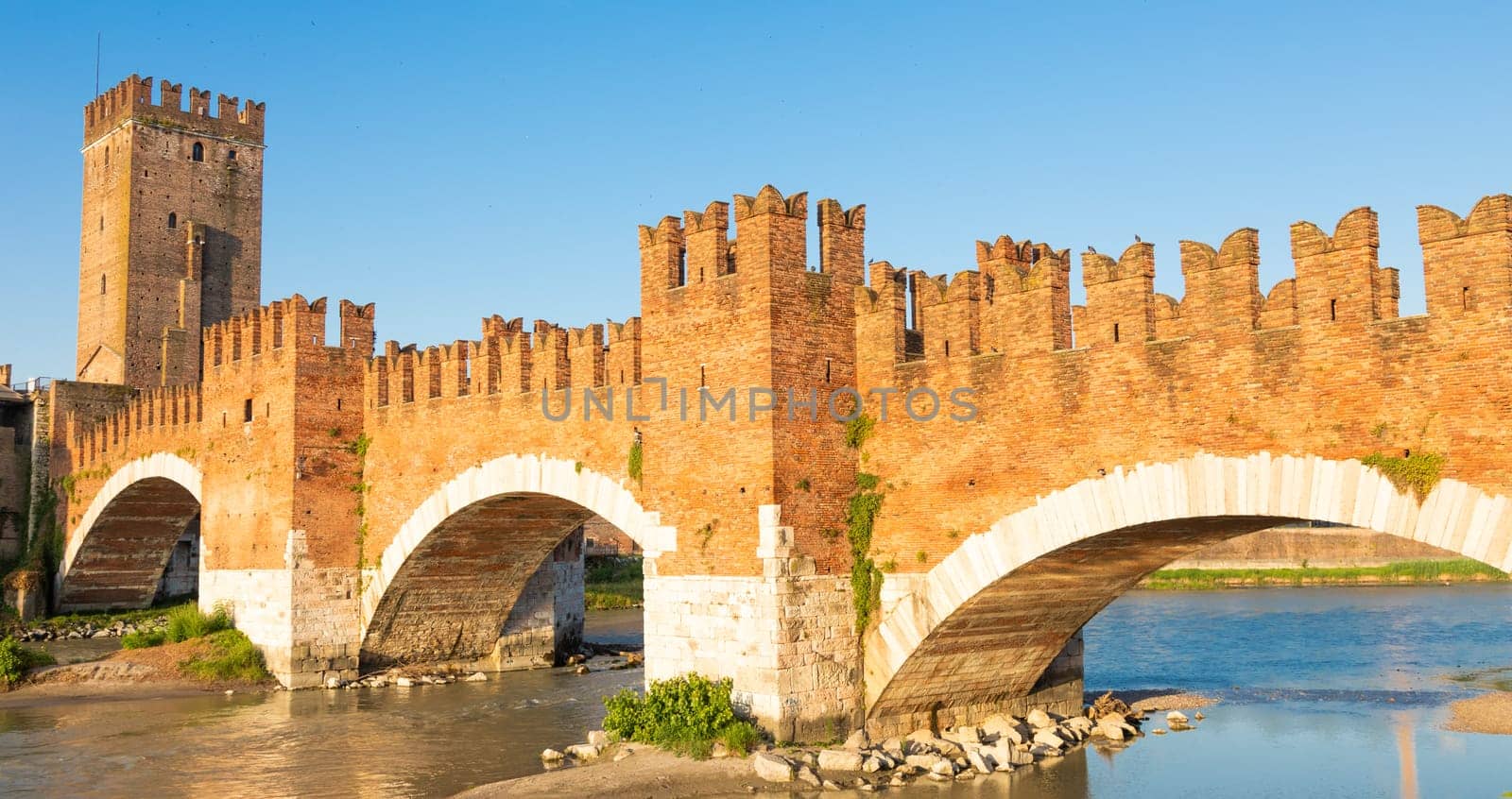 Verona, Italy. Castelvecchio bridge on Adige river. Old castle sightseeing at sunrise