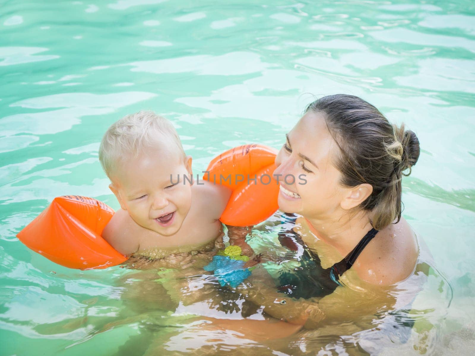 Baby and mother in swimming pool