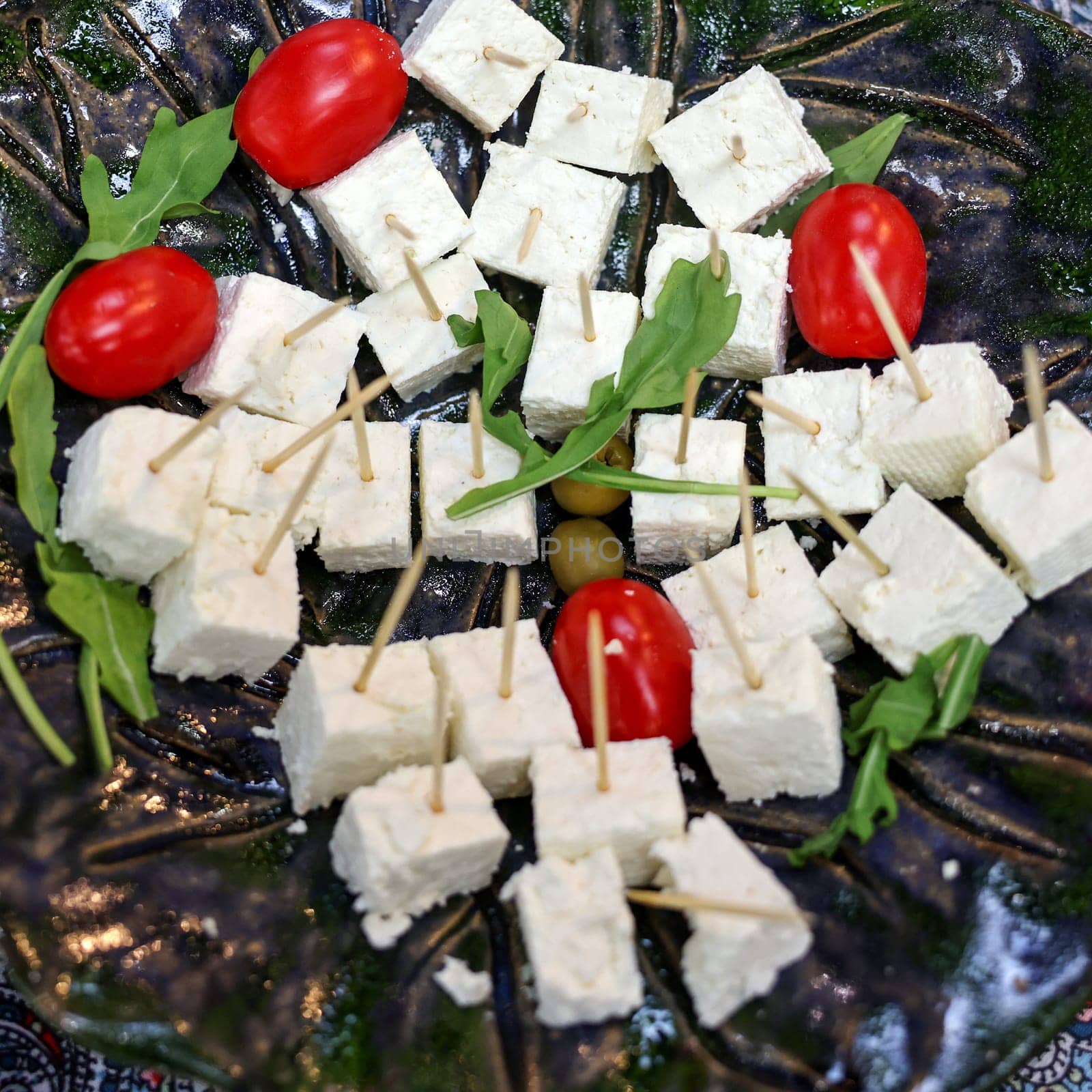 appetizers of white cheese and cherry tomatoes
