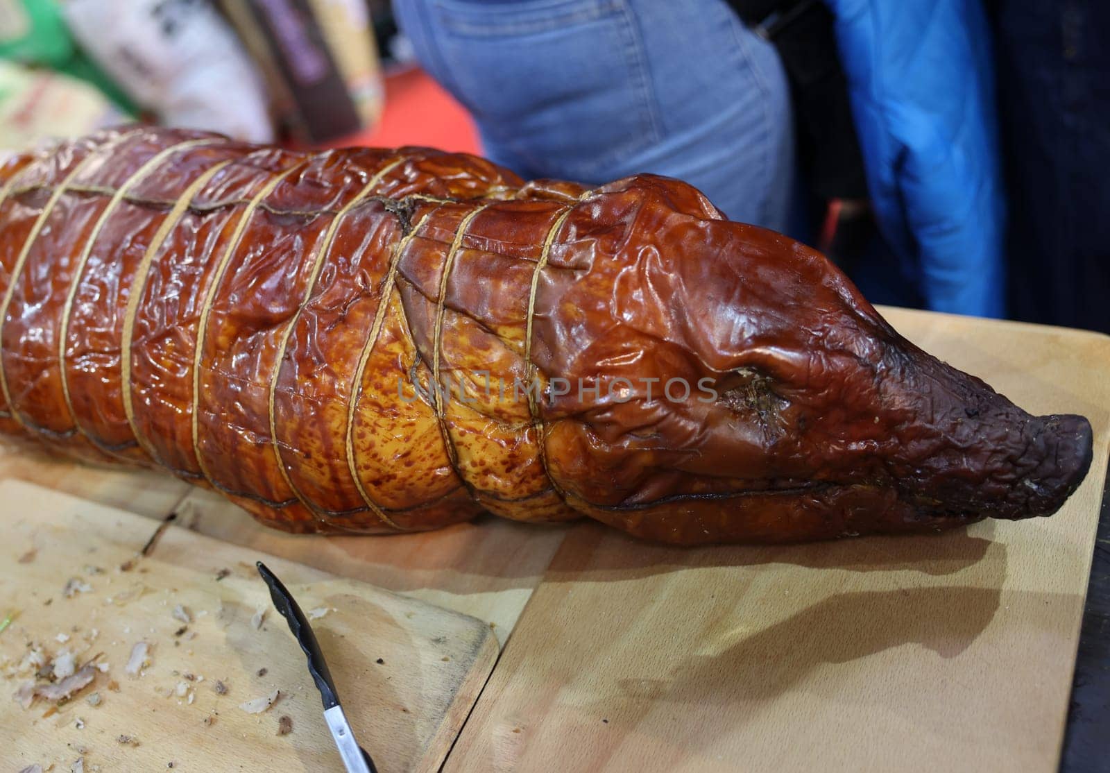 Baked suckling pig whole on a wooden board