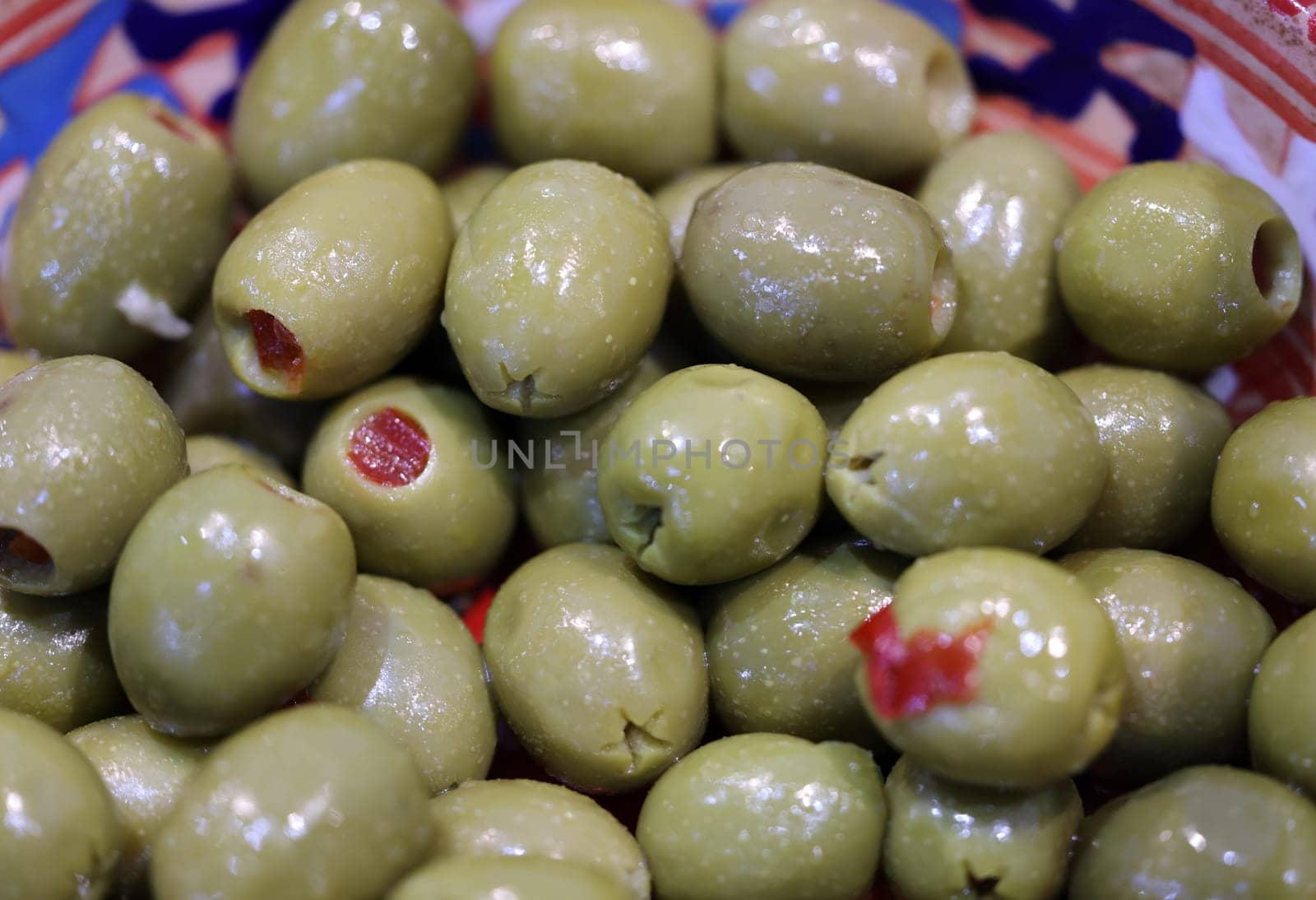 Stuffed green olives in an old wooden bowl