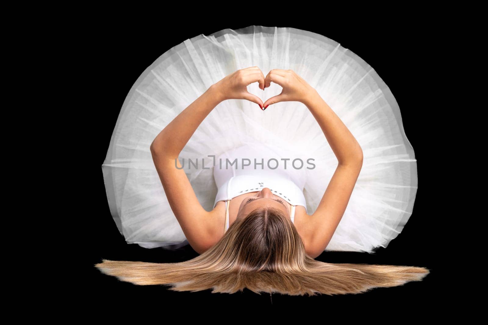 portrait of a ballerina in a pose, black background. High quality photo