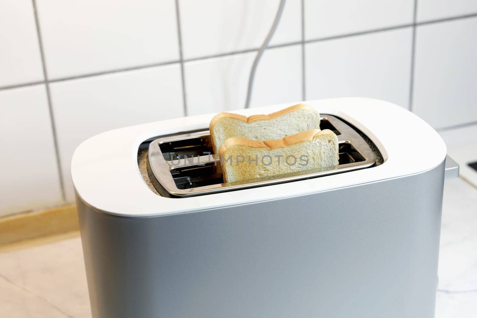 Toaster with two pieces of roasted bread. High quality photo