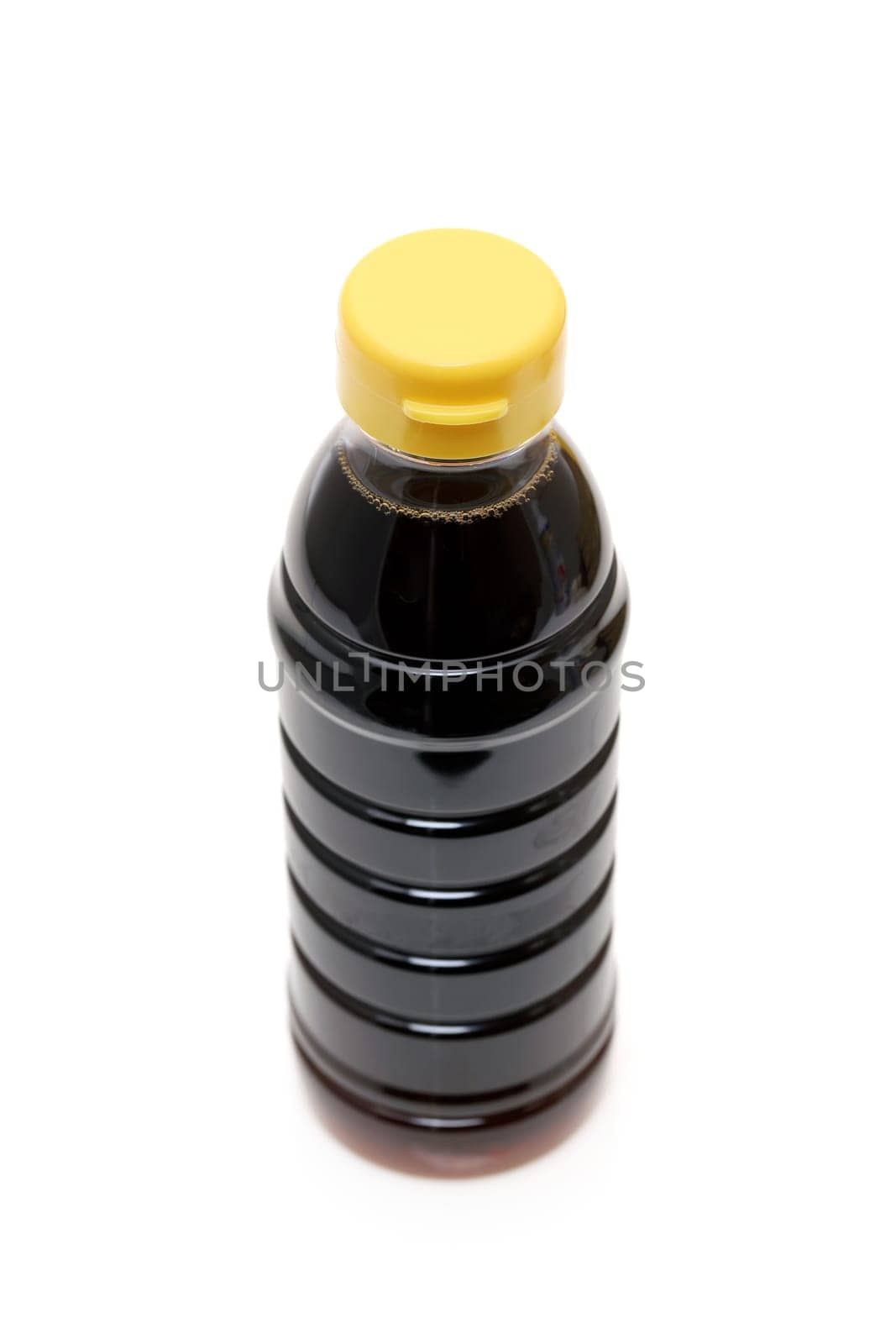 Plastic bottle of soy sauce on white background