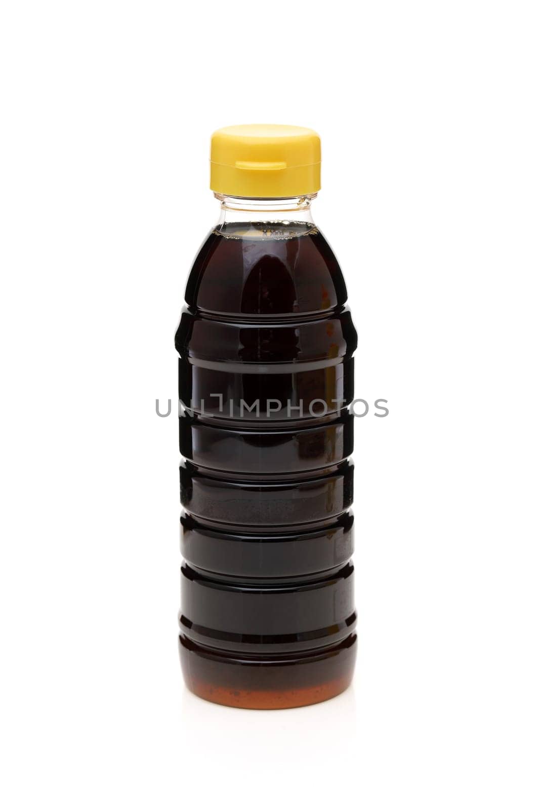 Plastic bottle of soy sauce on white background