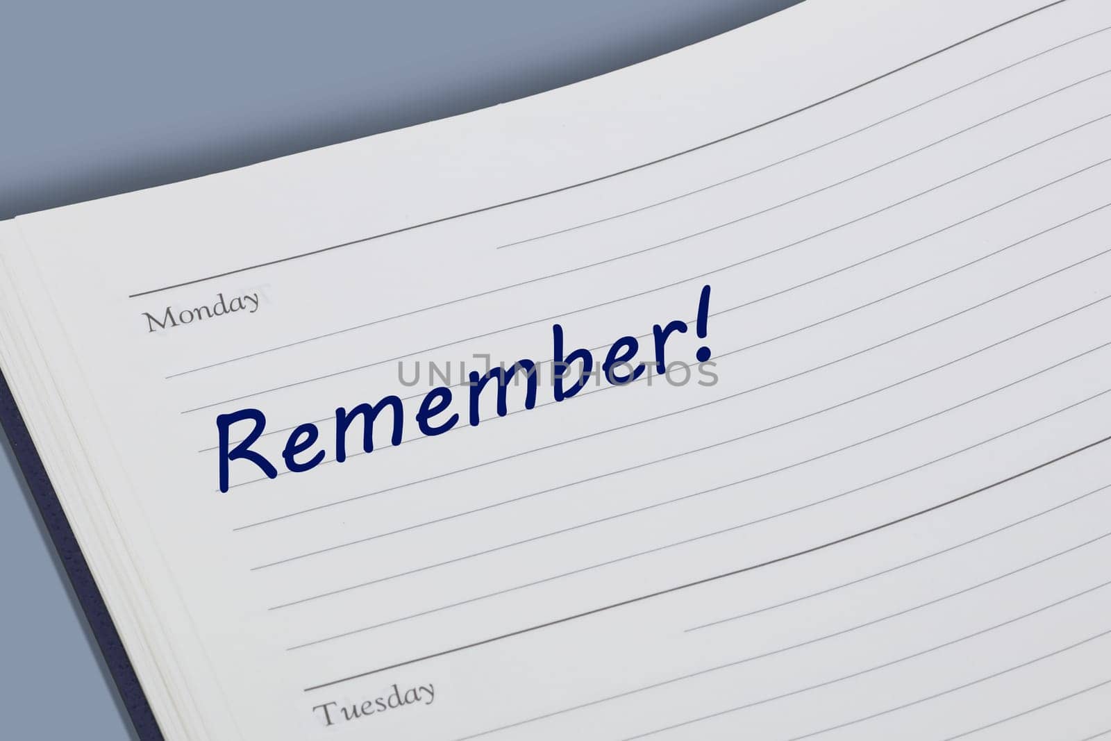 A Remember blue ink reminder note in a diary page