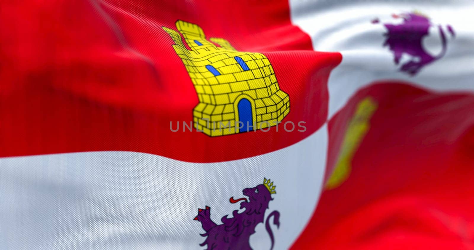 Close-up of Castile and Leon flag waving in the wind on a clear day. Castile and Leon is an autonomous community in north-western Spain. 3d illustration render. Selective focus. Rippled textile