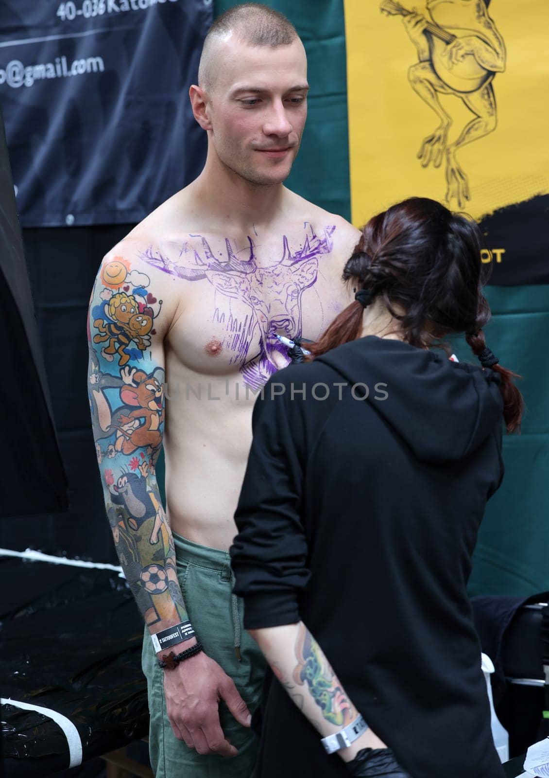 Krakow, Poland -  June 11, 2022: Unidentified  participant at 15th Tattoofest Convention in Cracow. One of the most prestigious tattoo festivals. Tattoo artist at work.