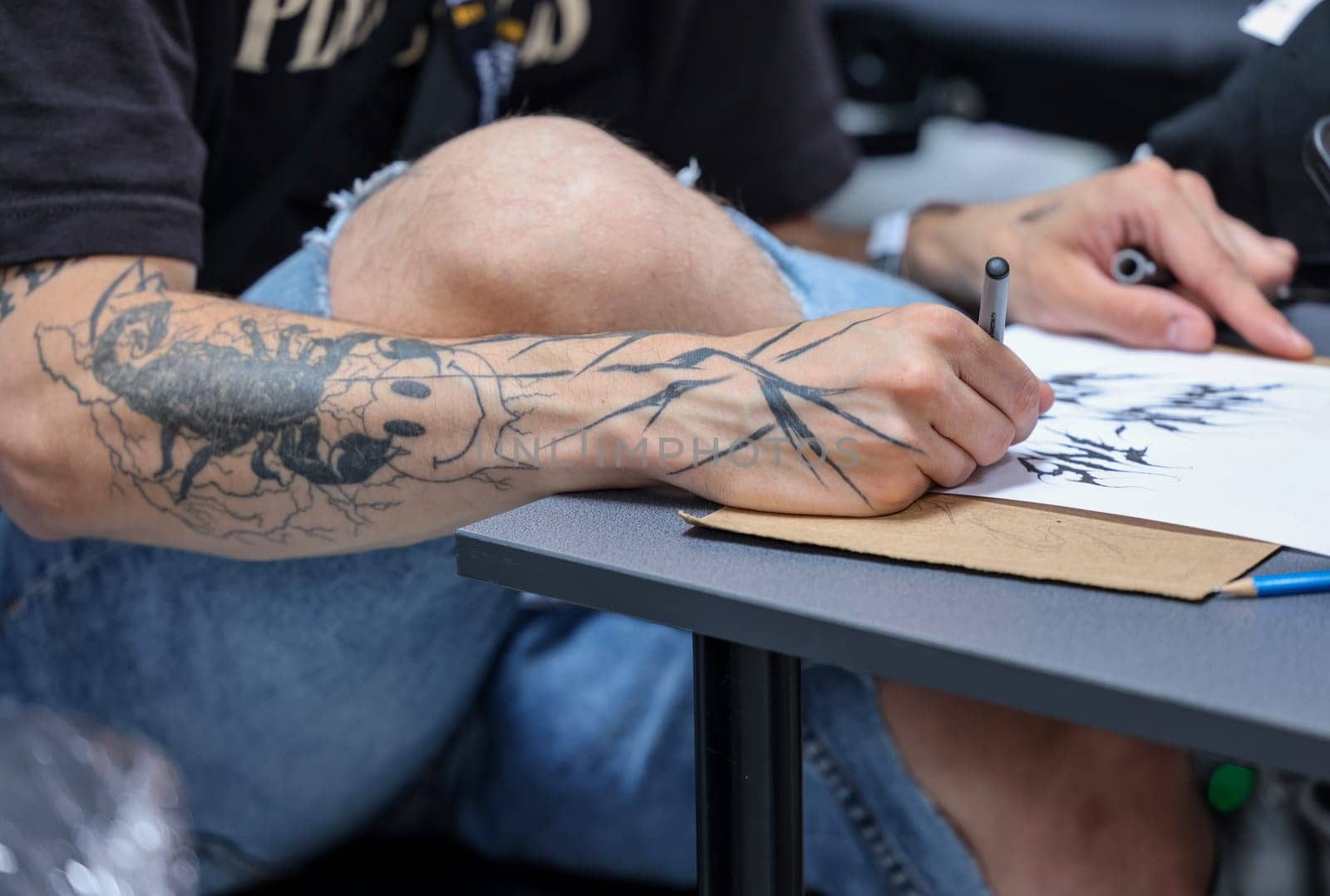 Krakow, Poland -  June 11, 2022: 15th Tattoofest Convention in Cracow. One of the most prestigious tattoo festivals. Tattoo artist at work.