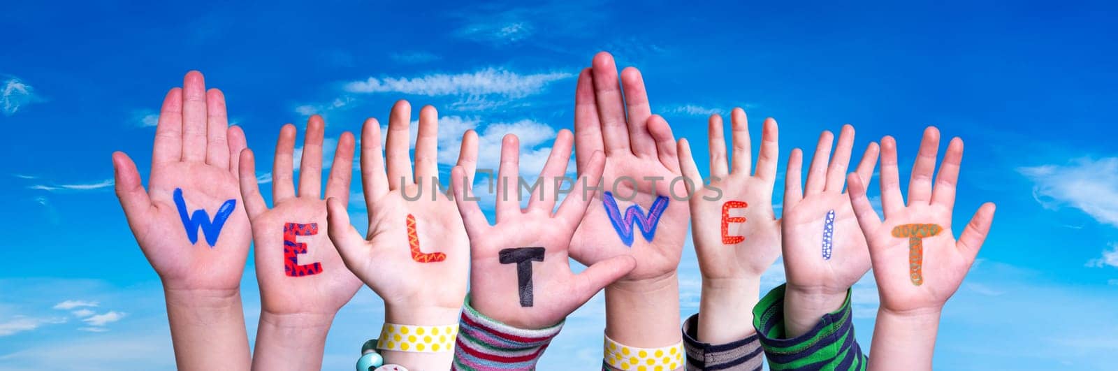 Children Hands Building Colorful German Word Weltweit Means Worldwide. Blue Sky As Background