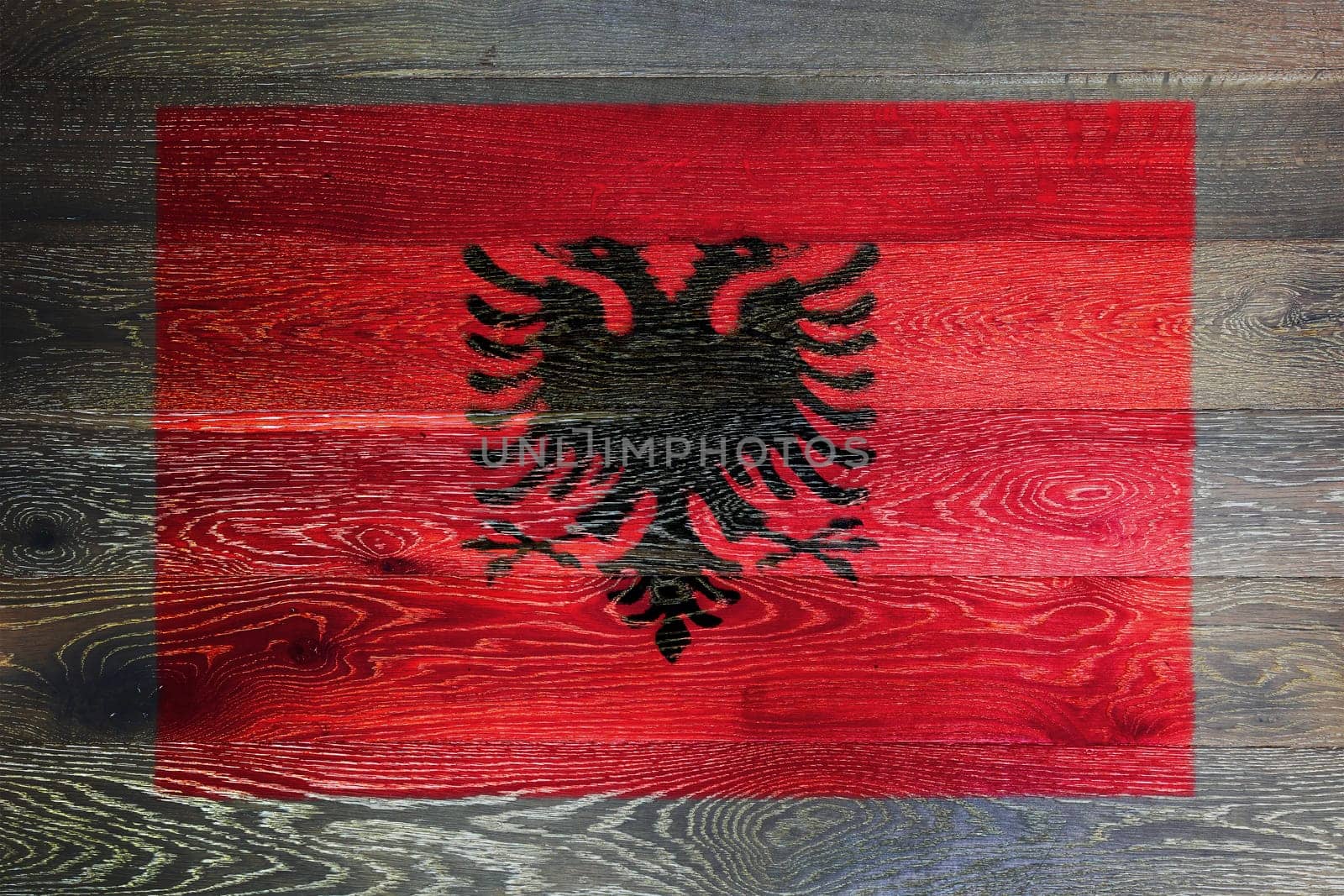 An Albania flag on rustic old wood surface background