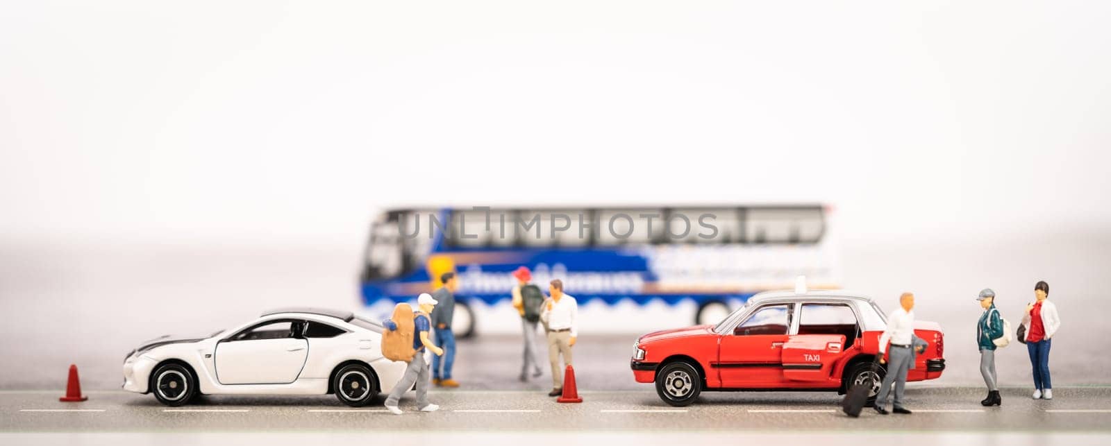 Land travel concept with miniature travelers