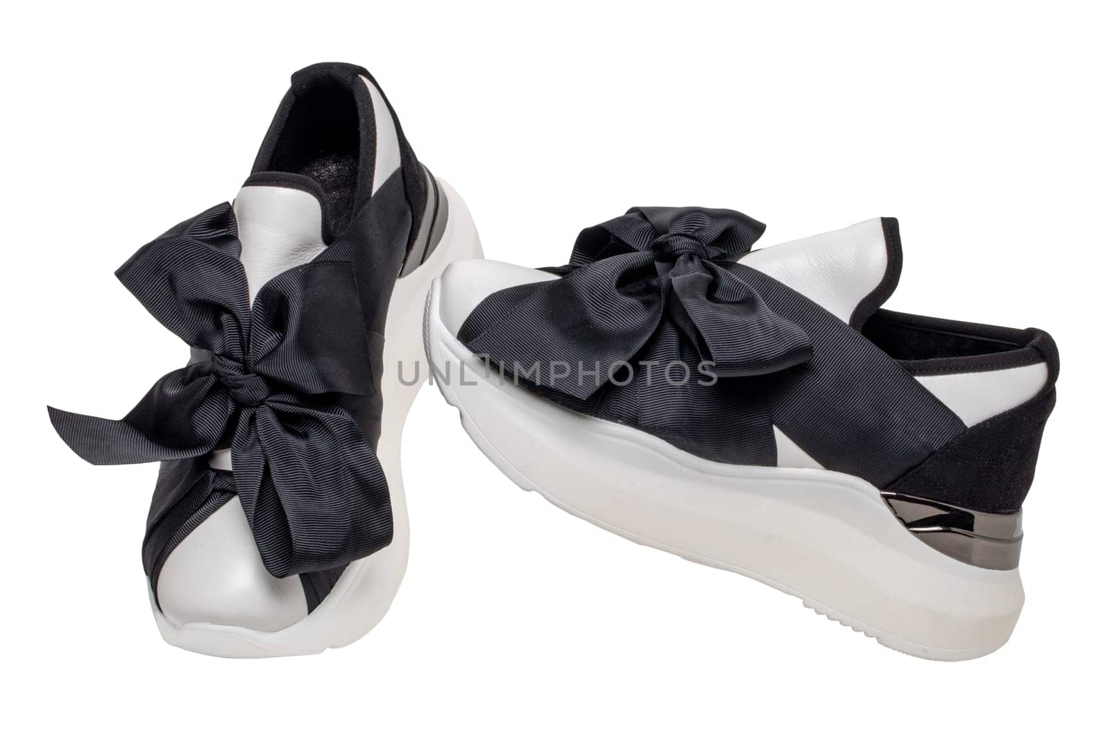 White sneaker isolated. Close-up of a pair black white elegant stylish female leather high-heeled sport shoes isolated. Clipping path. Womens shoe fashion. Modern design footwear for workout.