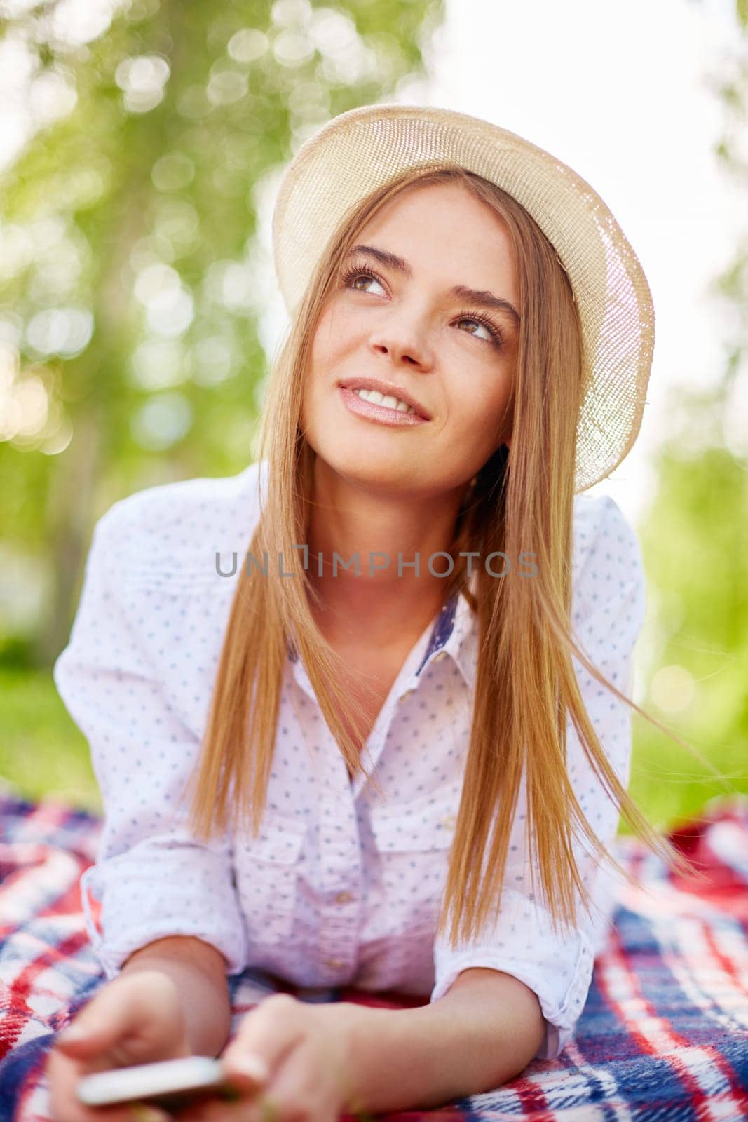 Happy girl in hat relaxing outside