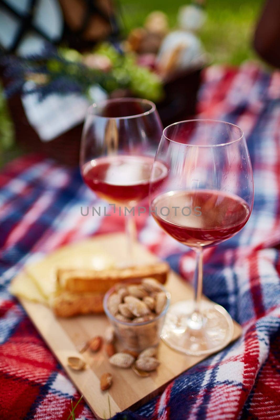 Two glasses with red wine and pistachio nuts near by