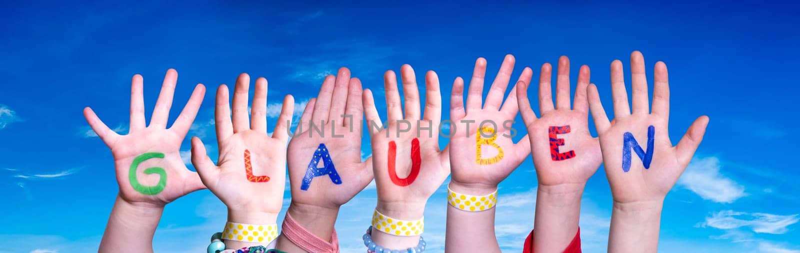 Children Hands Building Colorful German Word Glauben Means Believe. Blue Sky As Background.