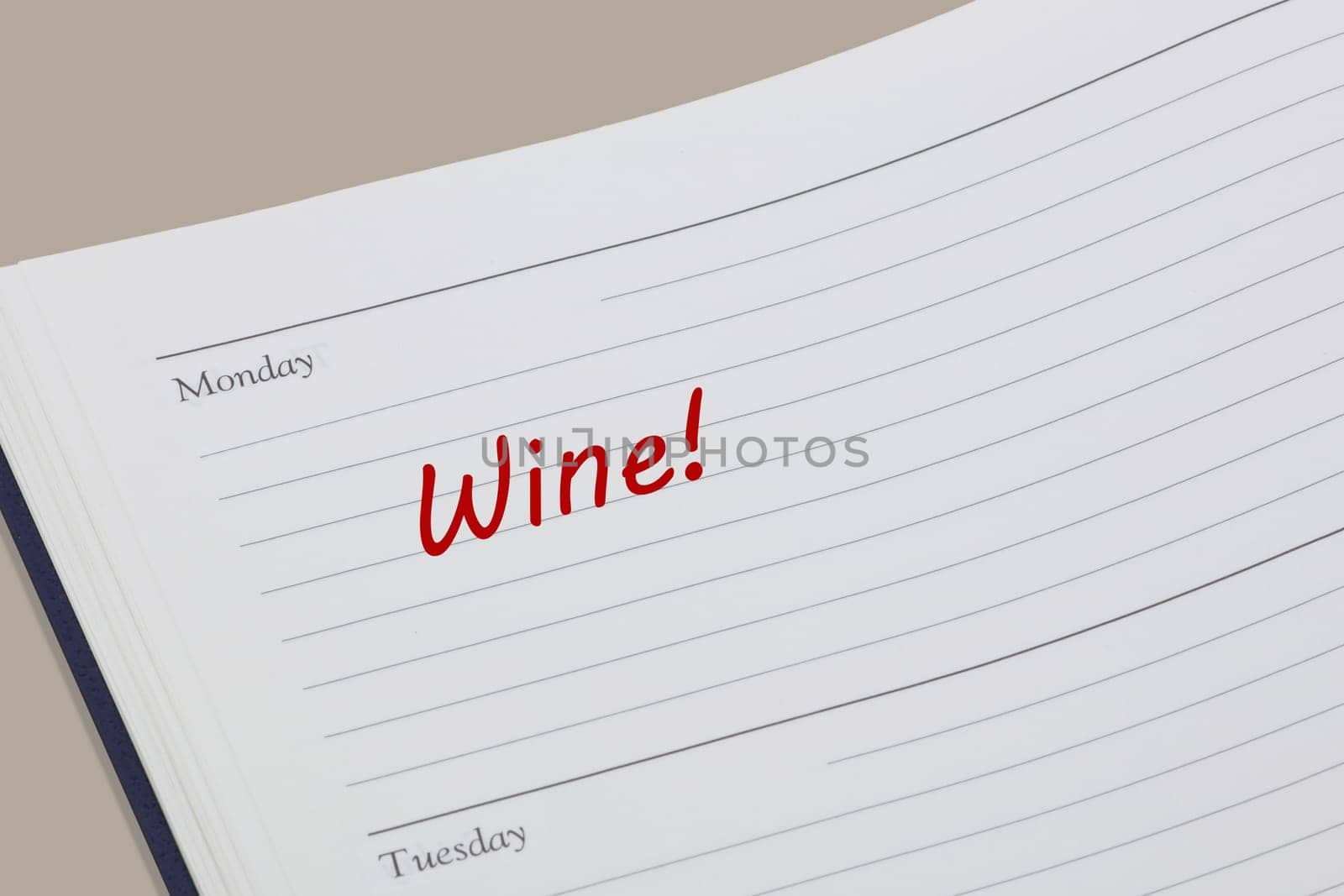 A Wine reminder note in red ink in a diary page
