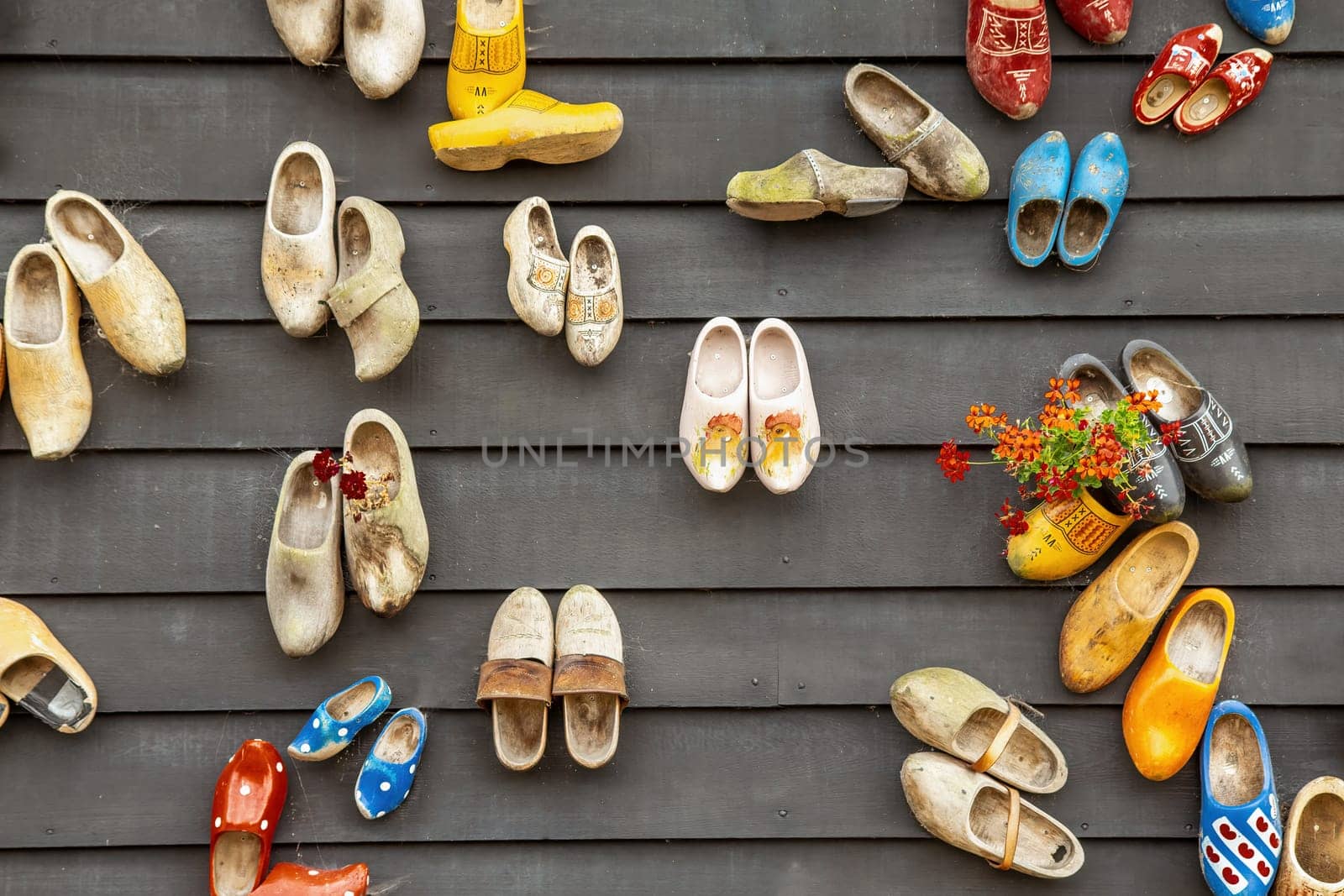 Traditional dutch wooden shoes hanging on a wall as decoration. Horizontally.