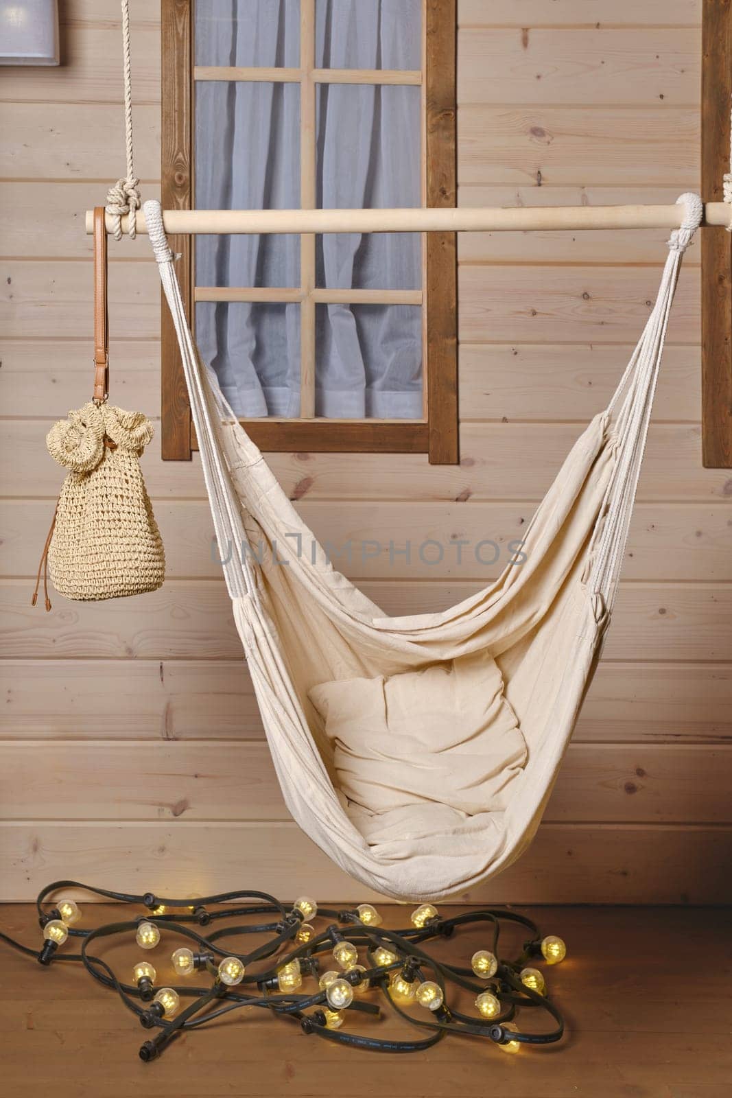 Empty hammock on the terrace of wooden cabin