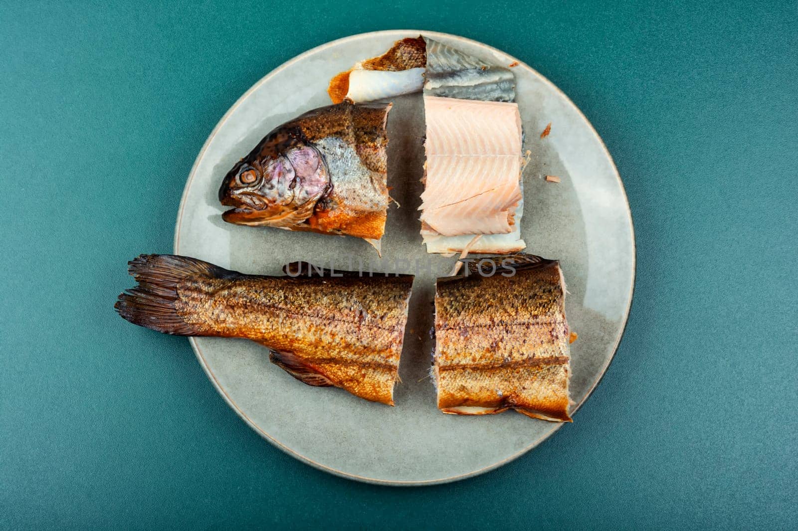 Dietary smoked trout salmon cut on a plate. Copy space