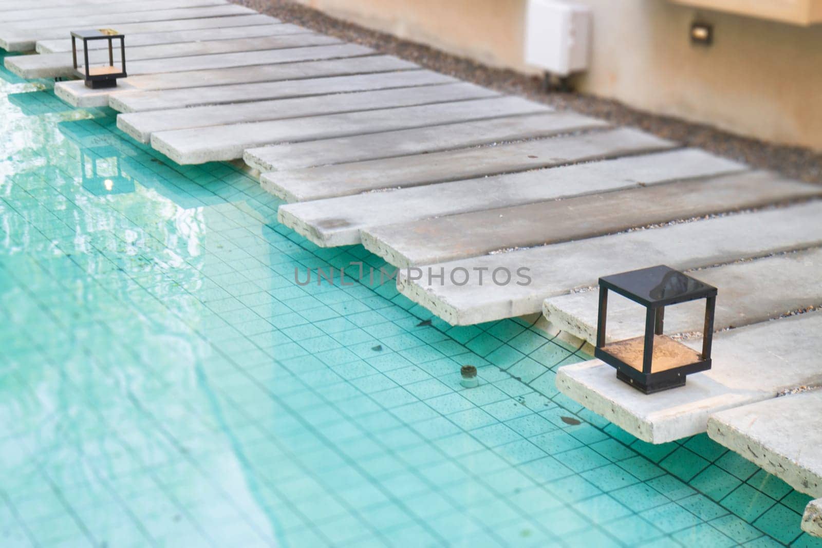 Mosaic in green transparent water at the bottom of the pool, stock photo