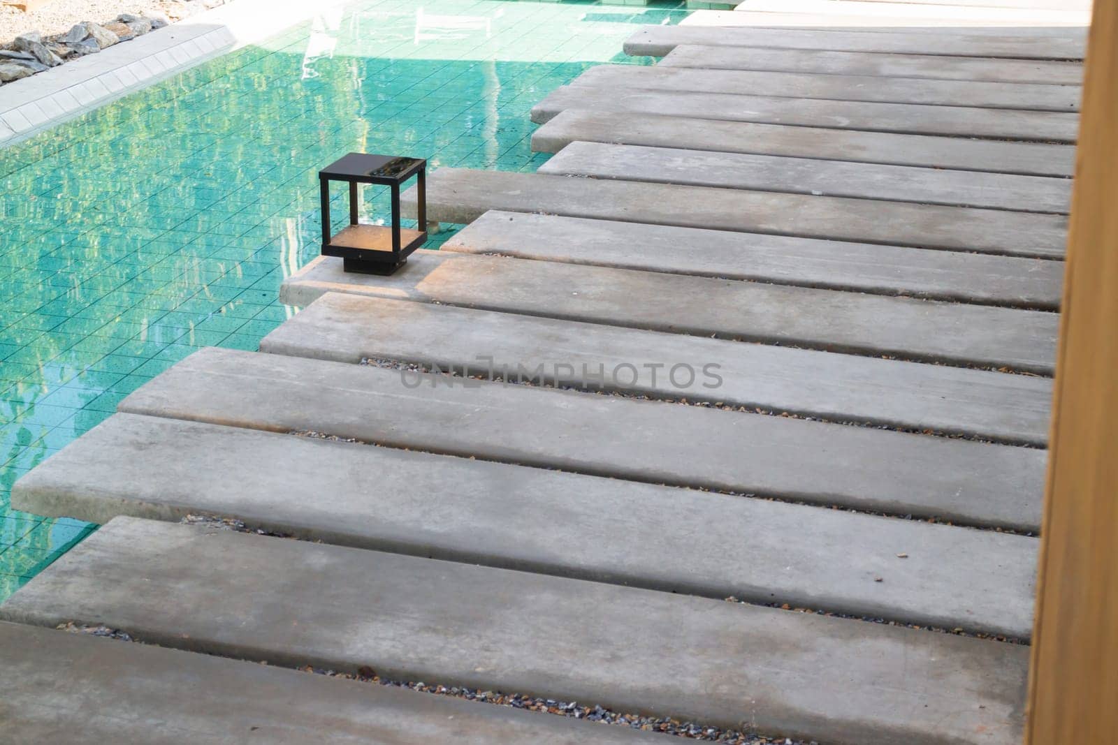 Mosaic in green transparent water at the bottom of the pool, stock photo