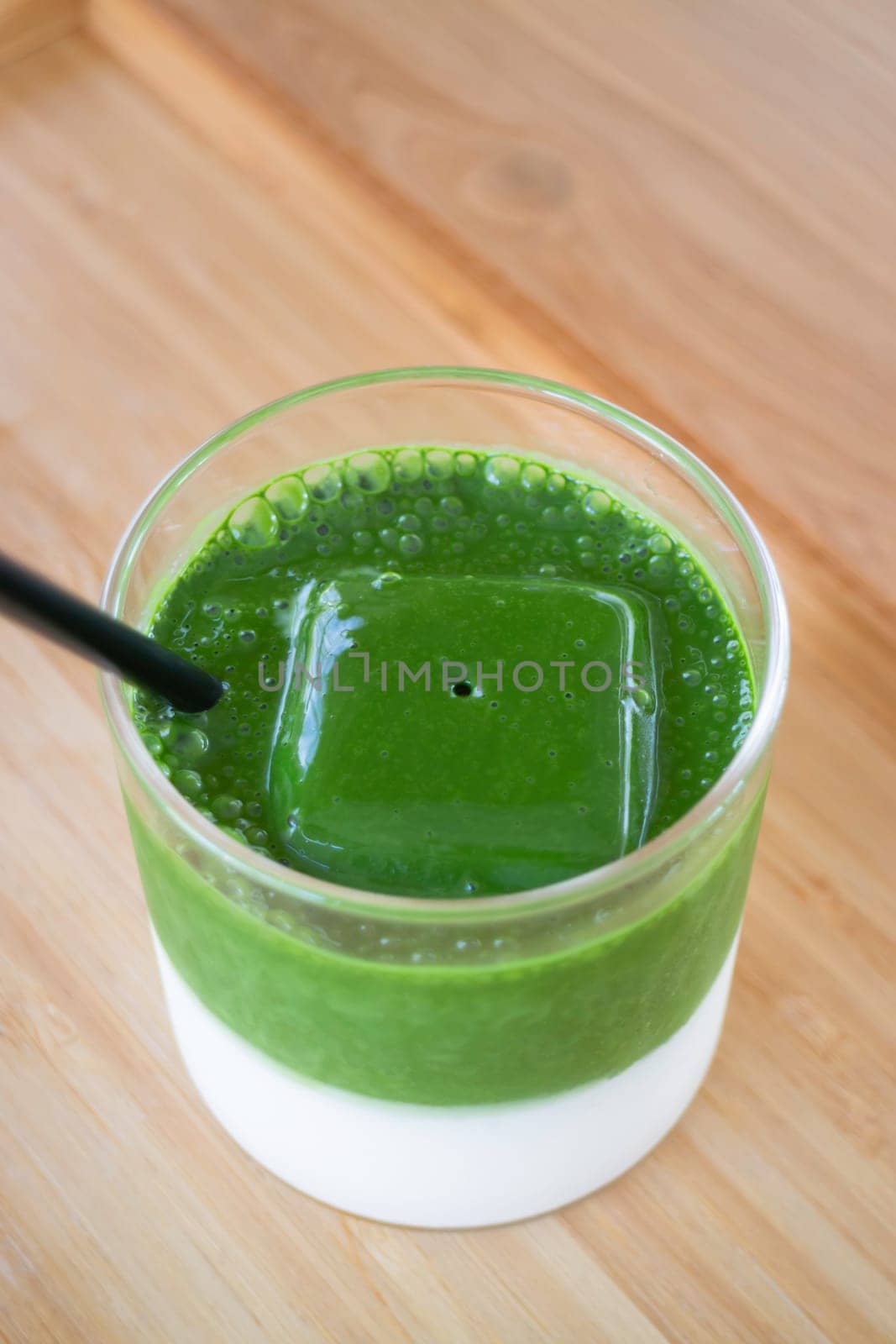 Iced matcha greentea on wooden table, stock photo