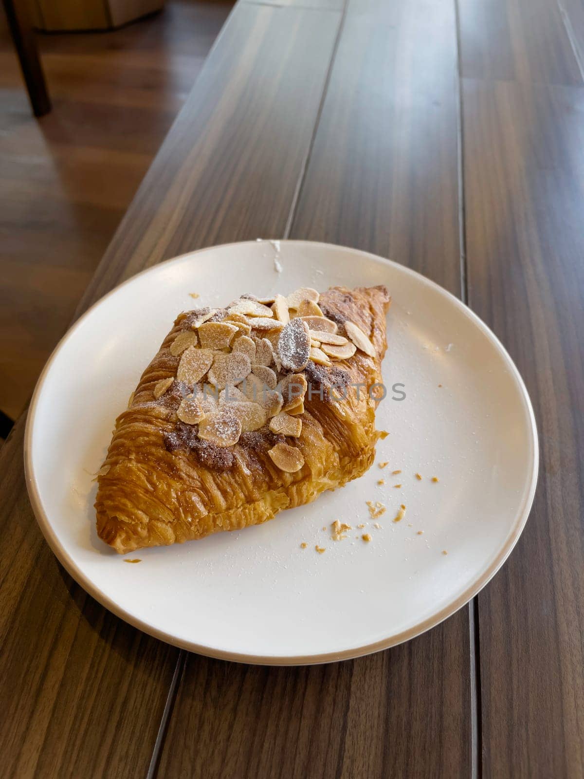 Fresh baked almond croissant and coffee breakfast, stock photo