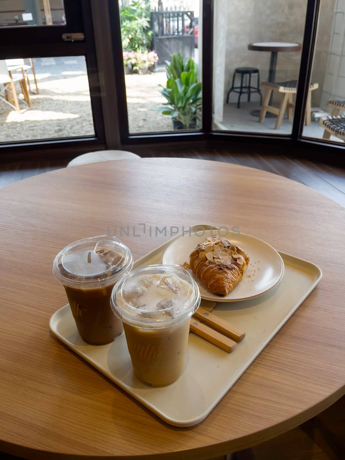 Fresh baked almond croissant and coffee breakfast, stock photo