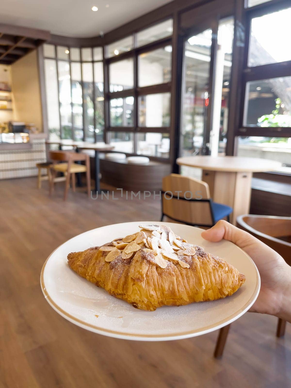 Fresh baked almond croissant and coffee breakfast, stock photo