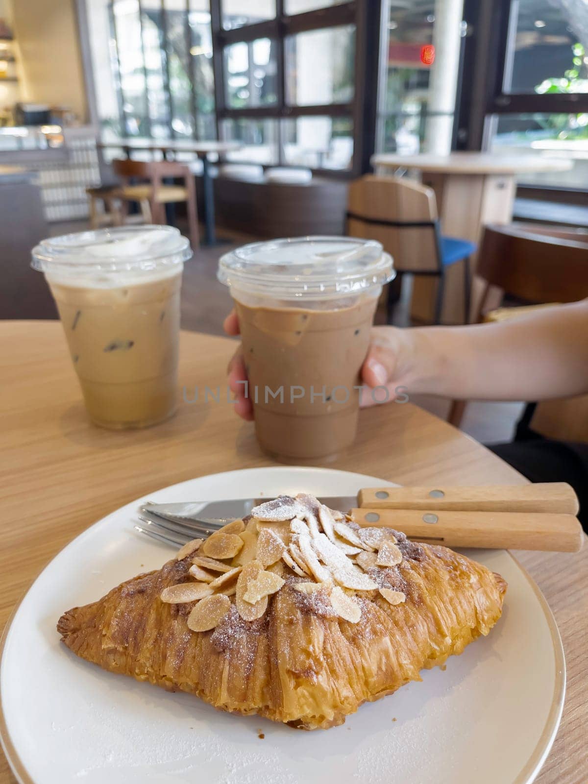 Fresh baked almond croissant and coffee breakfast, stock photo