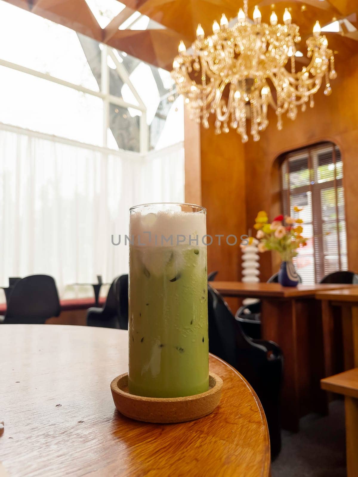 Iced matcha greentea on wooden table, stock photo