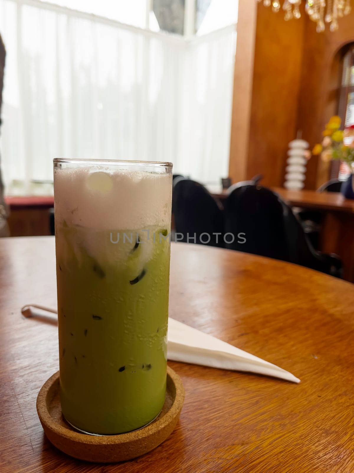 Iced matcha greentea on wooden table, stock photo