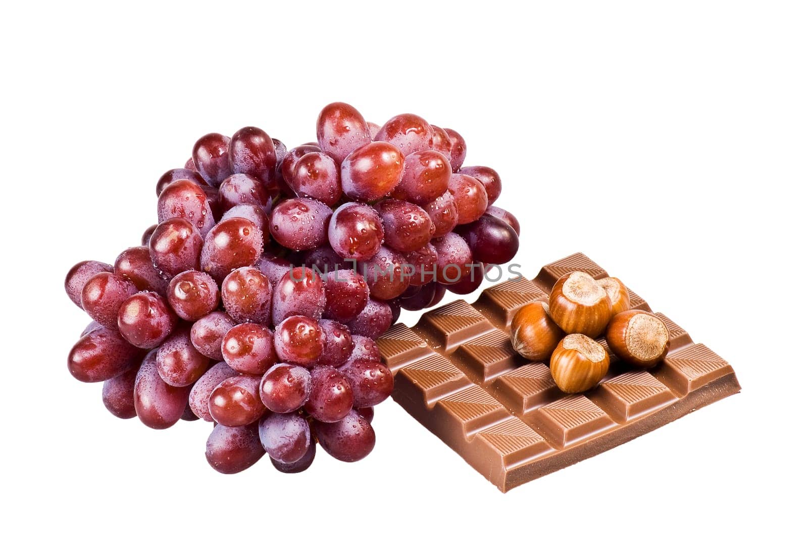 Red grapes with chocolate and nuts in shells on white background