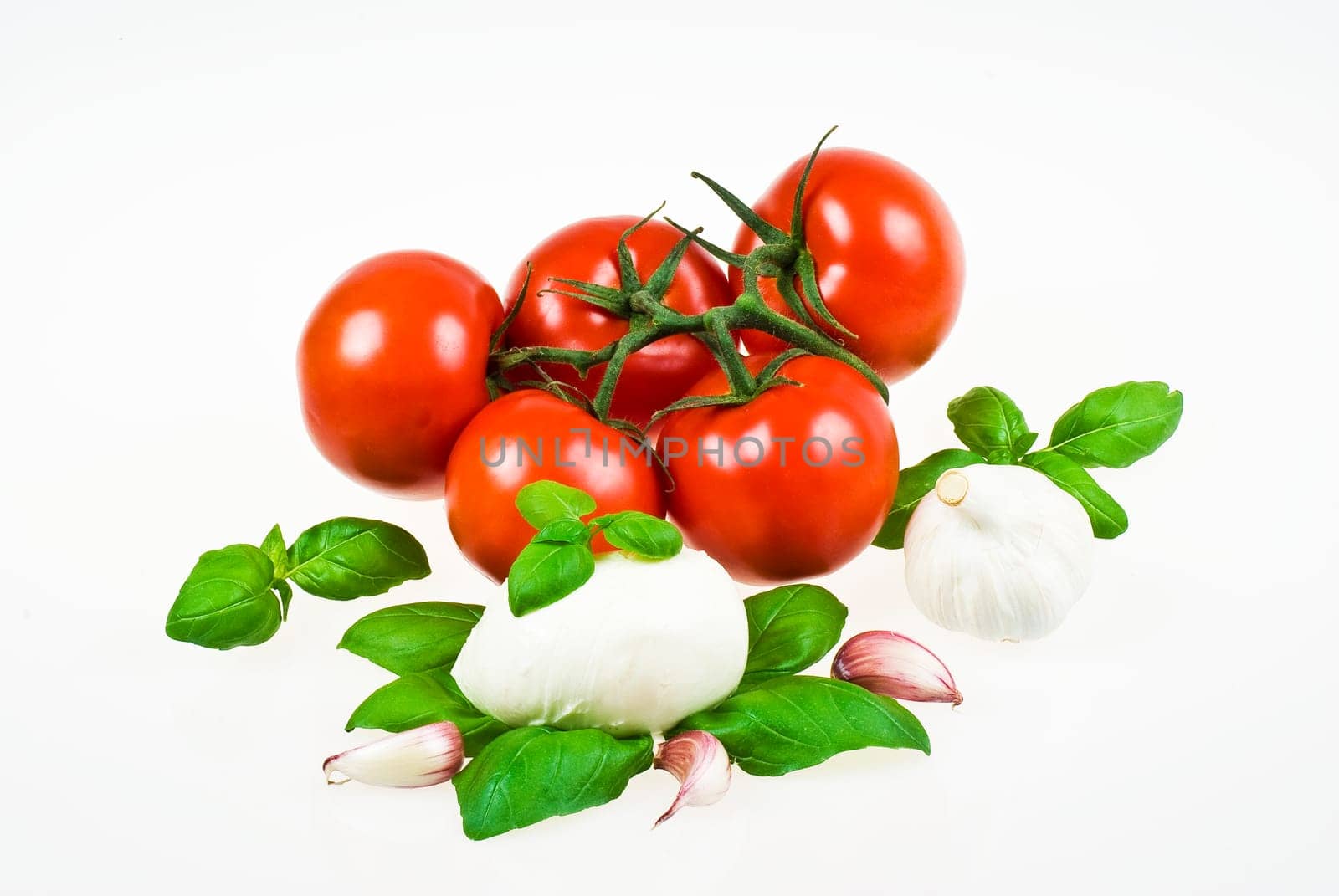 Bunch of tomatoes with mozzarella, garlic and basil